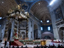A view of St. Peter's Basilica during the Mass for the solemnity of the Immaculate Conception, with Bernini's baldachin and the papal altar decorated with white flowers, Dec. 8, 2024.