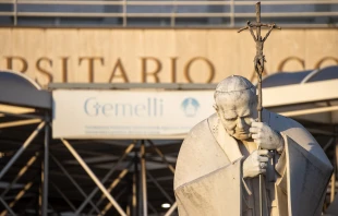 A statue of St. John Paul II is seen in front of the entrance to Rome's Gemelli hospital on Feb. 22, 2025, where Pope Francis continues to receive treatment for respiratory issues. Credit: Daniel Ibáñez/CNA