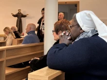 Faithful gather to pray during a Holy Hour at St. John Paul II Chapel at Gemelli Hospital in Rome, where Pope Francis is being treated for several medical conditions.