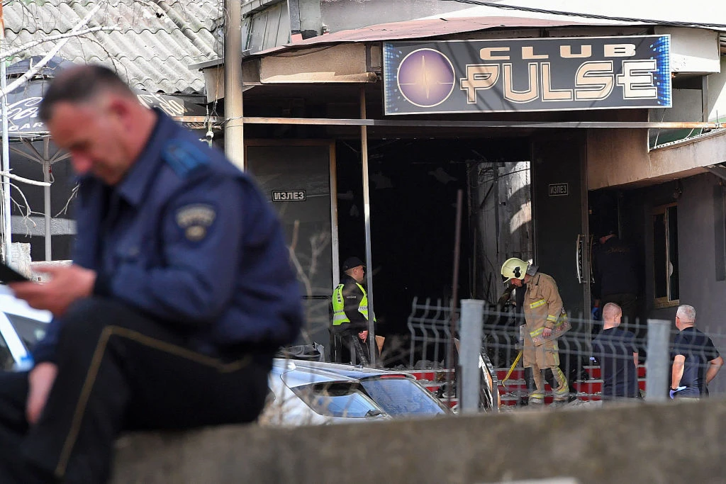 Firefighters and police officers inspect the nightclub where a fire broke out overnight in Kocani, a town some 62 miles east of the capital Skopje, on March 16, 2025. A fire tore through an overcrowded nightclub packed with mostly young people in North Macedonia overnight, killing 59 people, apparently after on-stage fireworks at a hip-hop concert set the venue ablaze, authorities said.?w=200&h=150