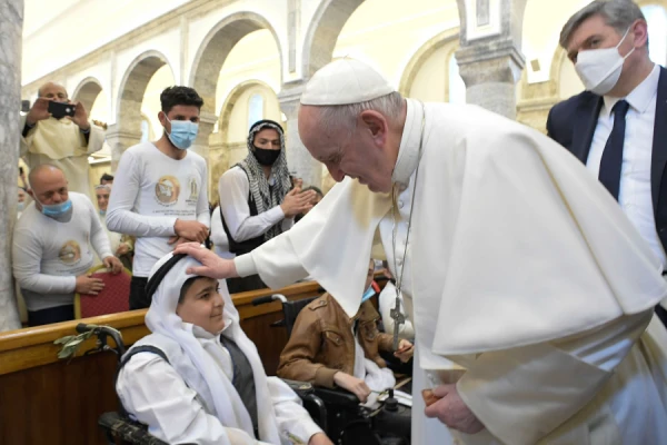 Pope Francis blesses a young boy in the Syriac Catholic Church of the Immaculate Conception in Bakhdida, Iraq, on March 7, 2021. Photo credits: Vatican Media.